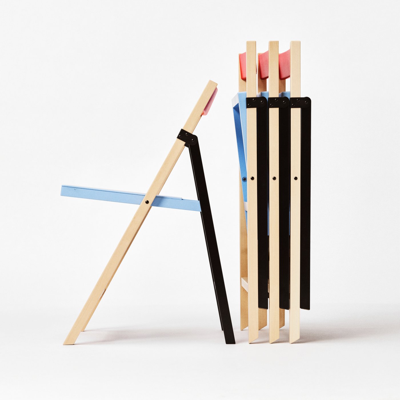 The side view of 4 IKEA PS 2026 folding chairs, with 1 open to a seat.