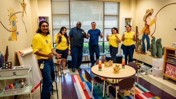 six IKEA coworkers posing in an IKEA designed room