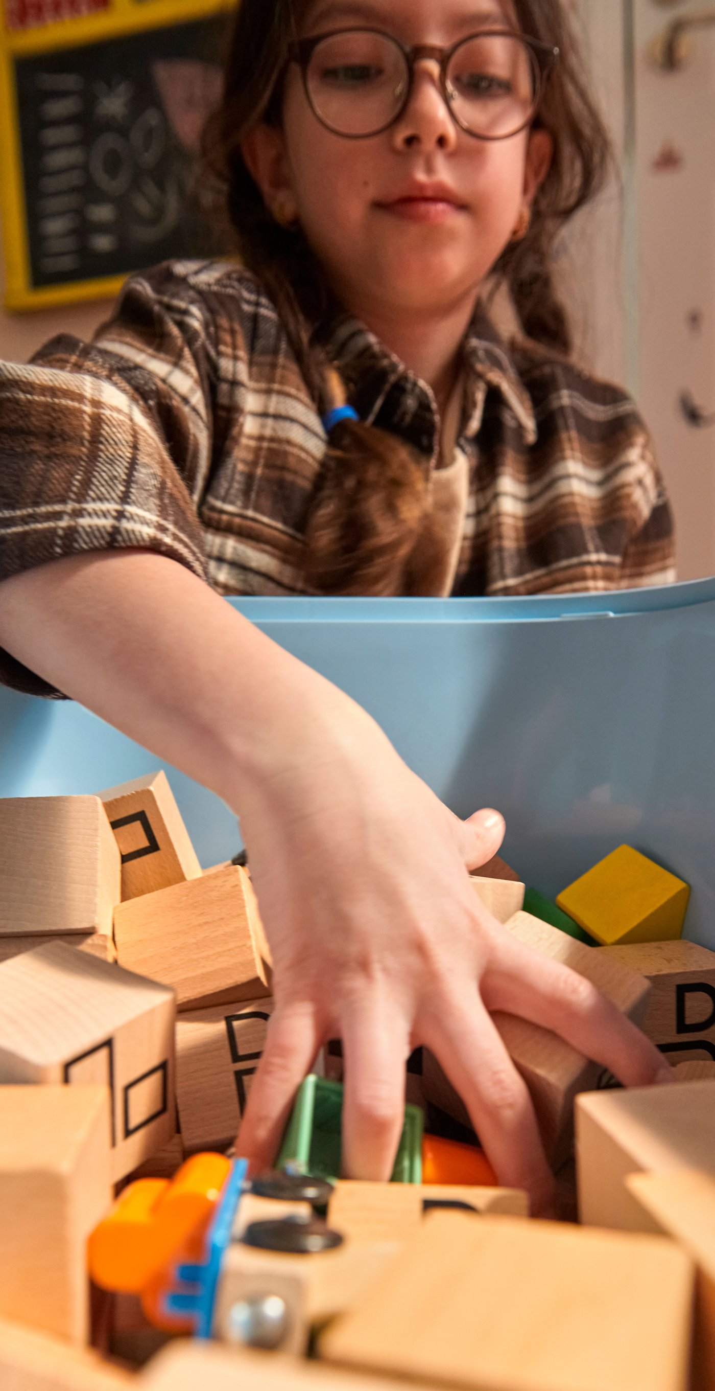 A light blue TROFAST storage box in the childrens room