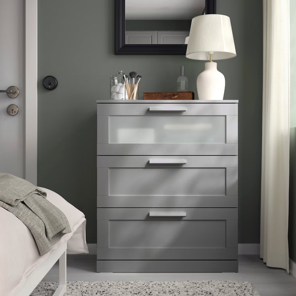 A grey/frosted glass BRIMNES chest of 3 drawers
