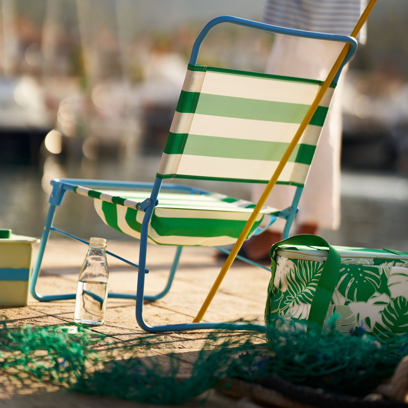 A patterned/bright green SOMMARFLOX cooling bag