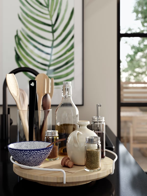 APTITLIG lazy susan on a kitchen counter, neatly displaying kitchen essentials such as spices, oil bottles, and utensils.