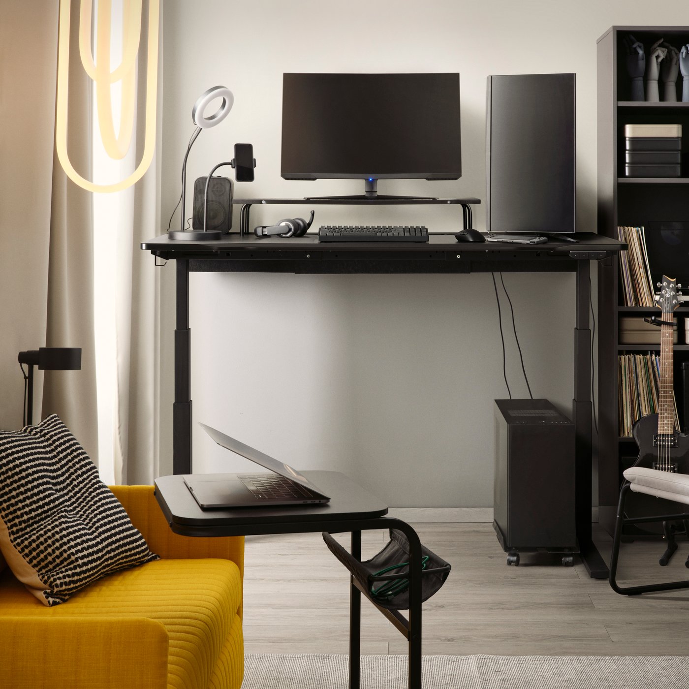 An electric/black UTMANING gaming desk sit/stand