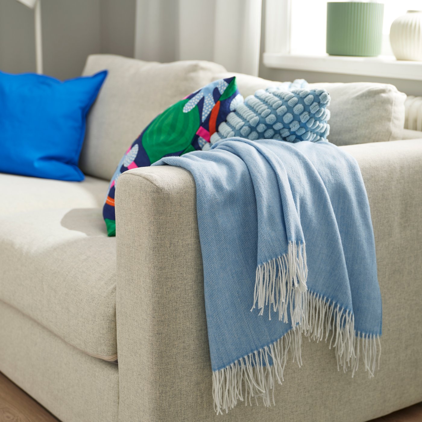 A blue HOLMVI throw 120x160cm