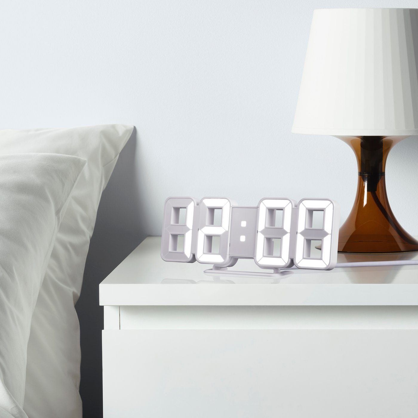 A white NOLLÅTTA alarm clock