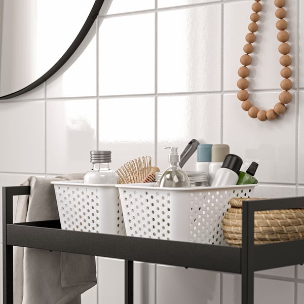 A white PLOGSVÄNG storage basket