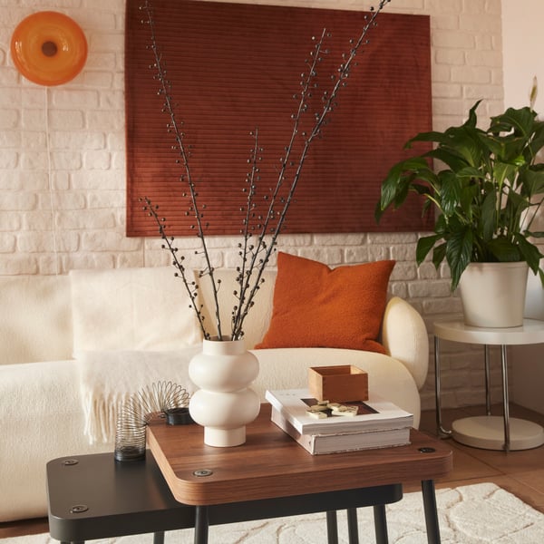 A living room features a PÄRLHÄGG vase placed on a coffee table, in front of an Axvall off-white LILLESÄTER 3-seat sofa.