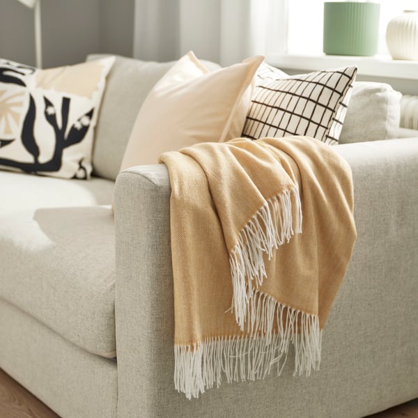 A beige-yellow HOLMVI throw