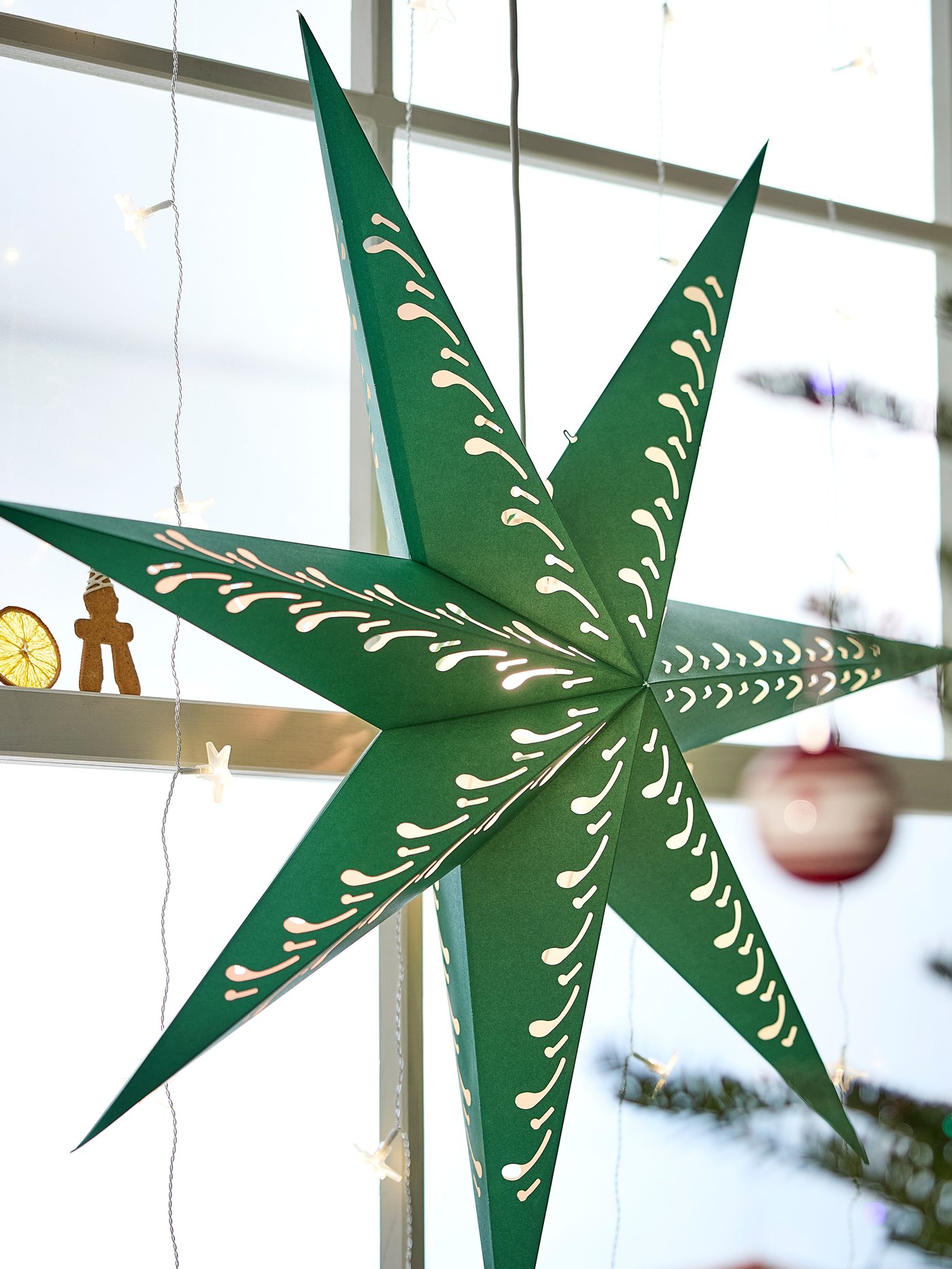 A paper star/green white STRÅLA lampshade