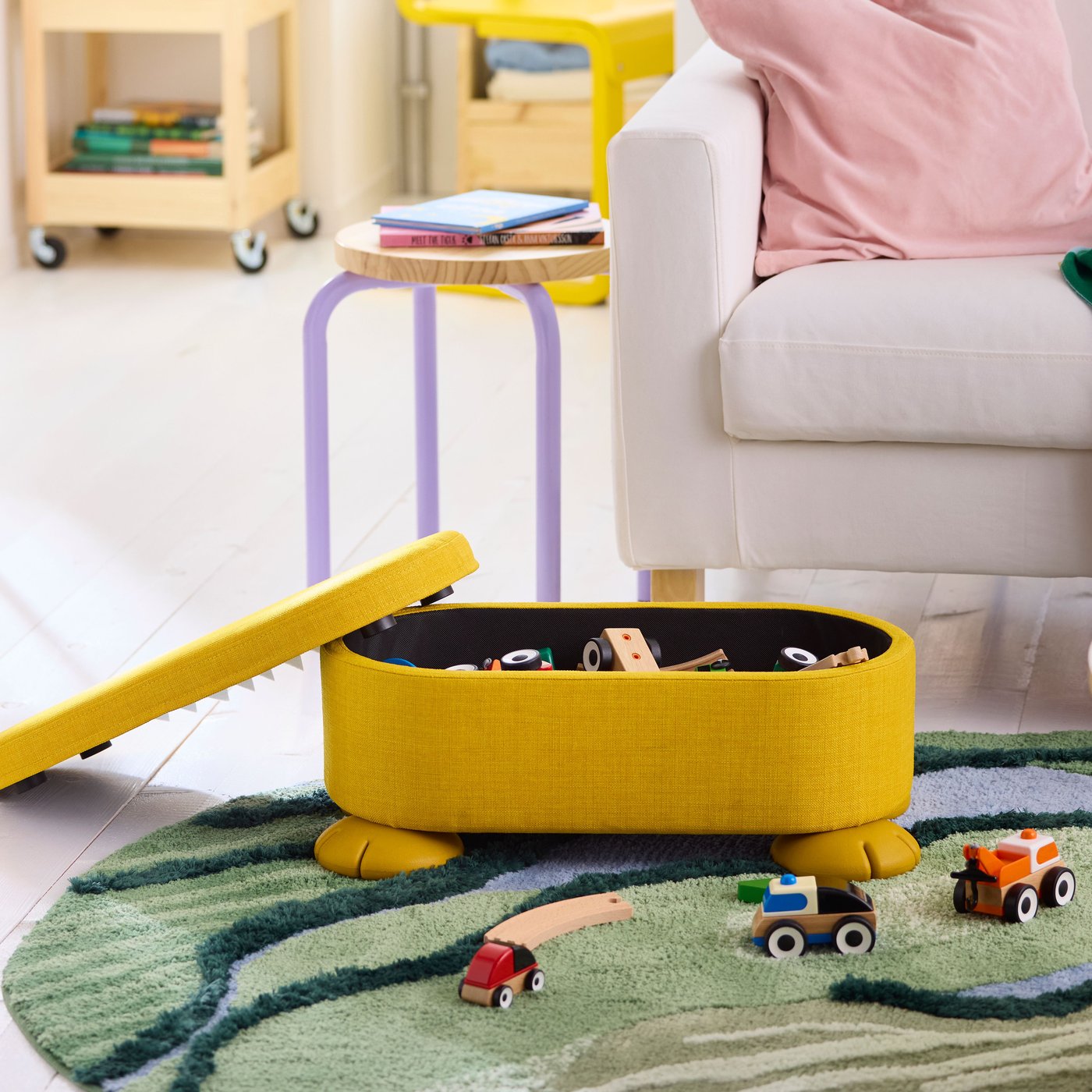 An yellow GREJSIMOJS pouffe with storage in the NA