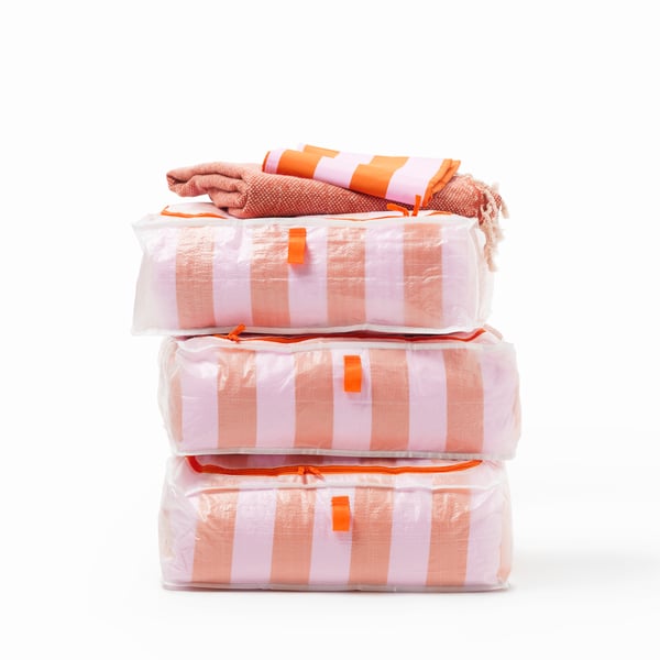 An orange/pink/striped SLÅNHÖSTMAL duvet cover and pillowcase