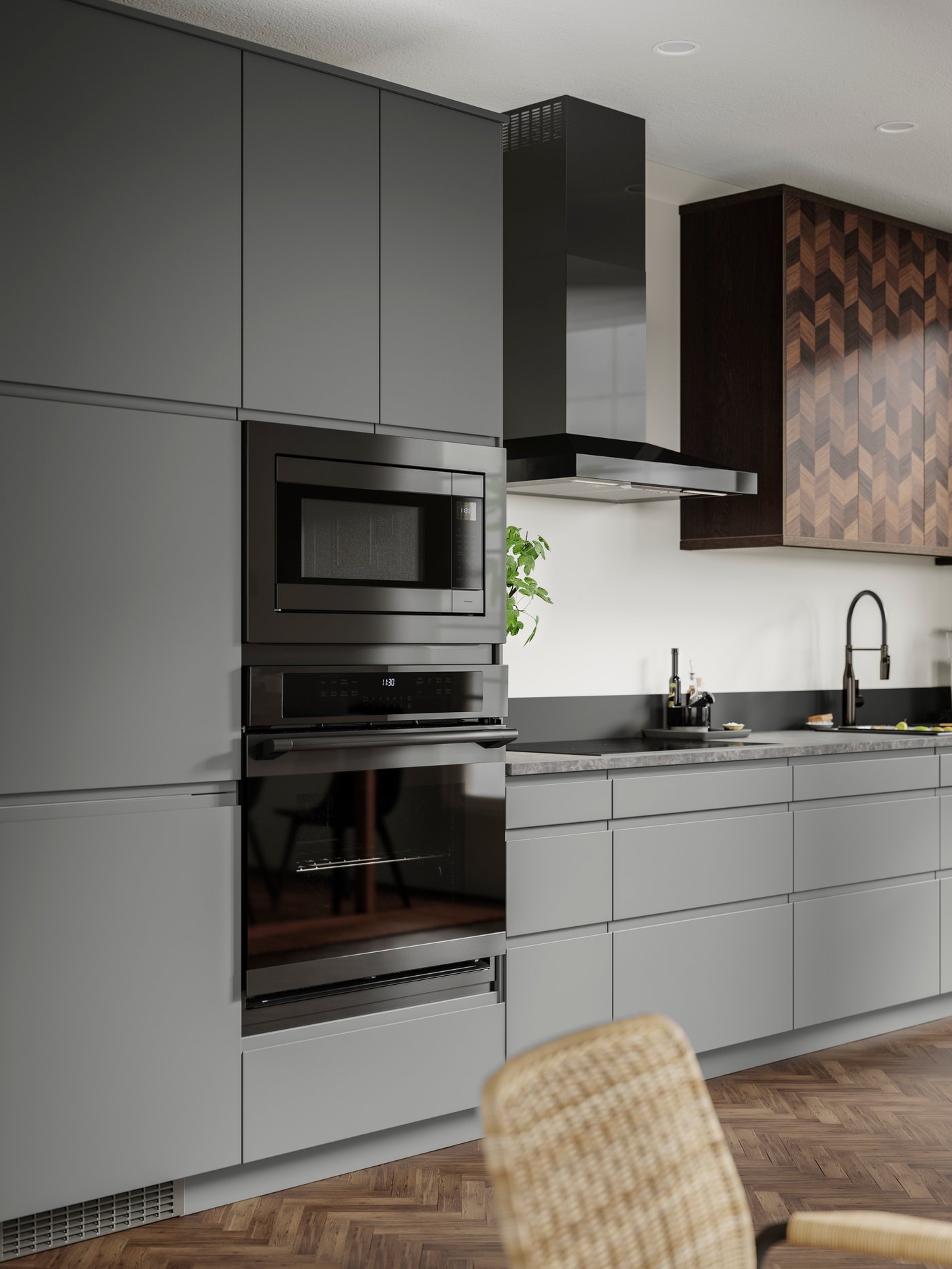 A kitchen with grey VOXTORP fronts and two ovens one above the other.