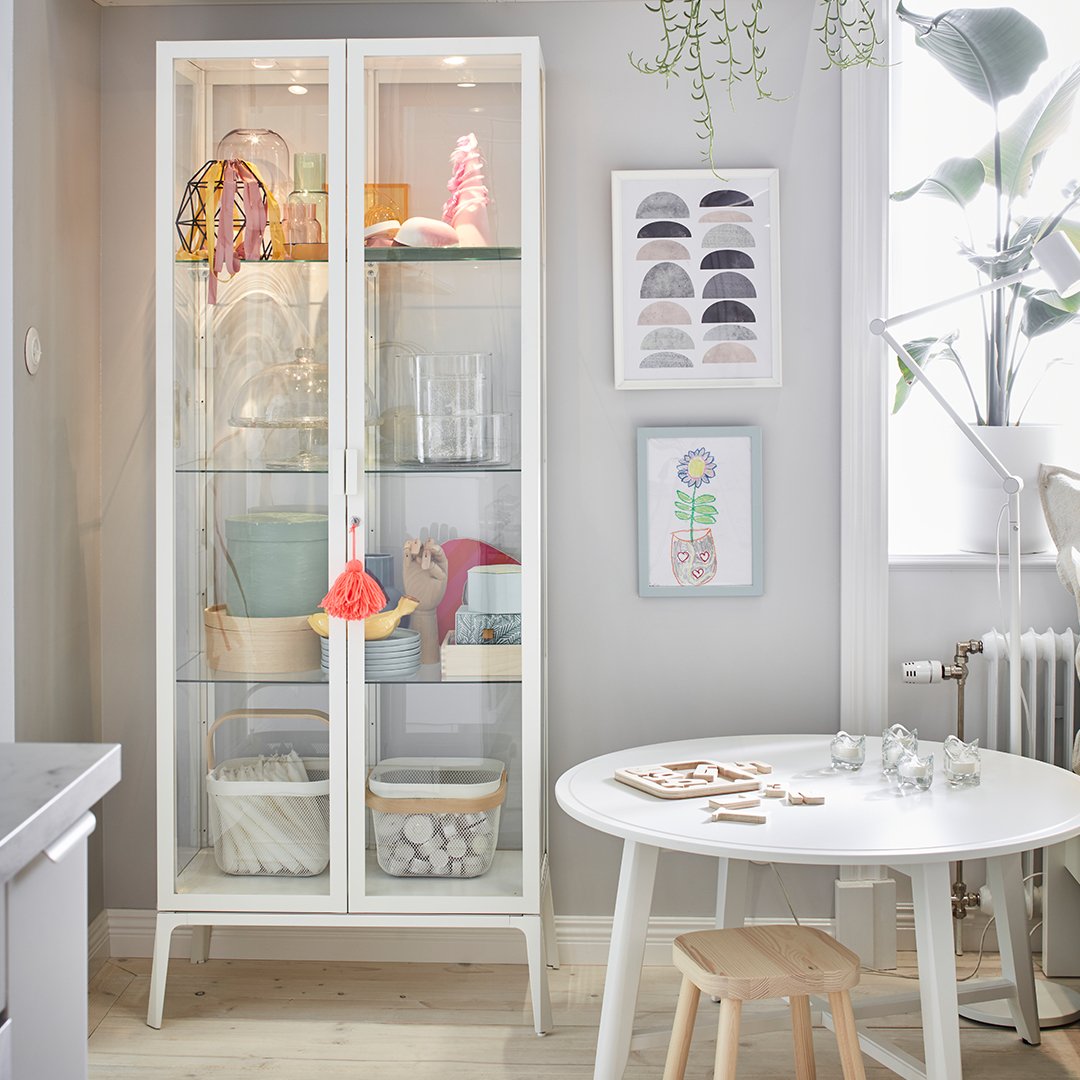 A white PLATSA open shelving unit in the dining room