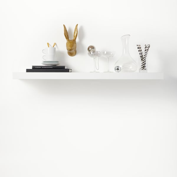 A white LACK wall shelf installed on a white wall looks like it’s floating because it has no visible brackets.
