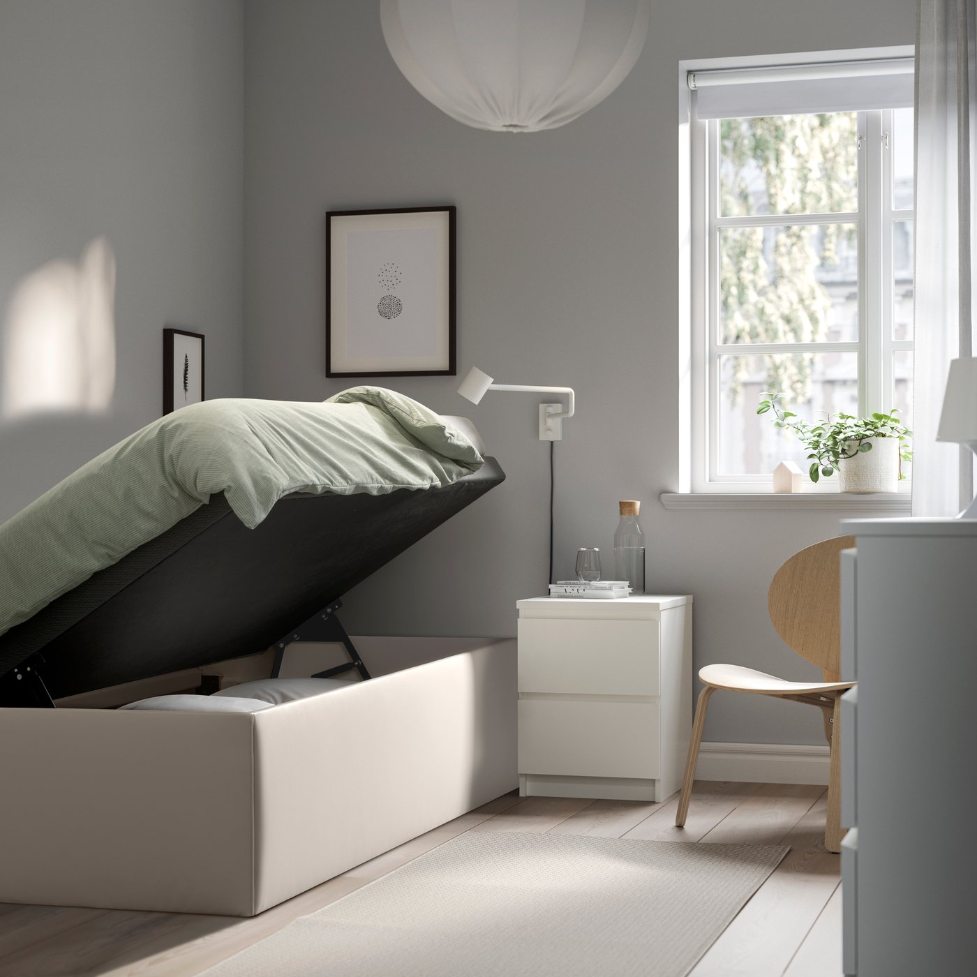 A Bomstad white TJÅLLE upholstered ottoman bed