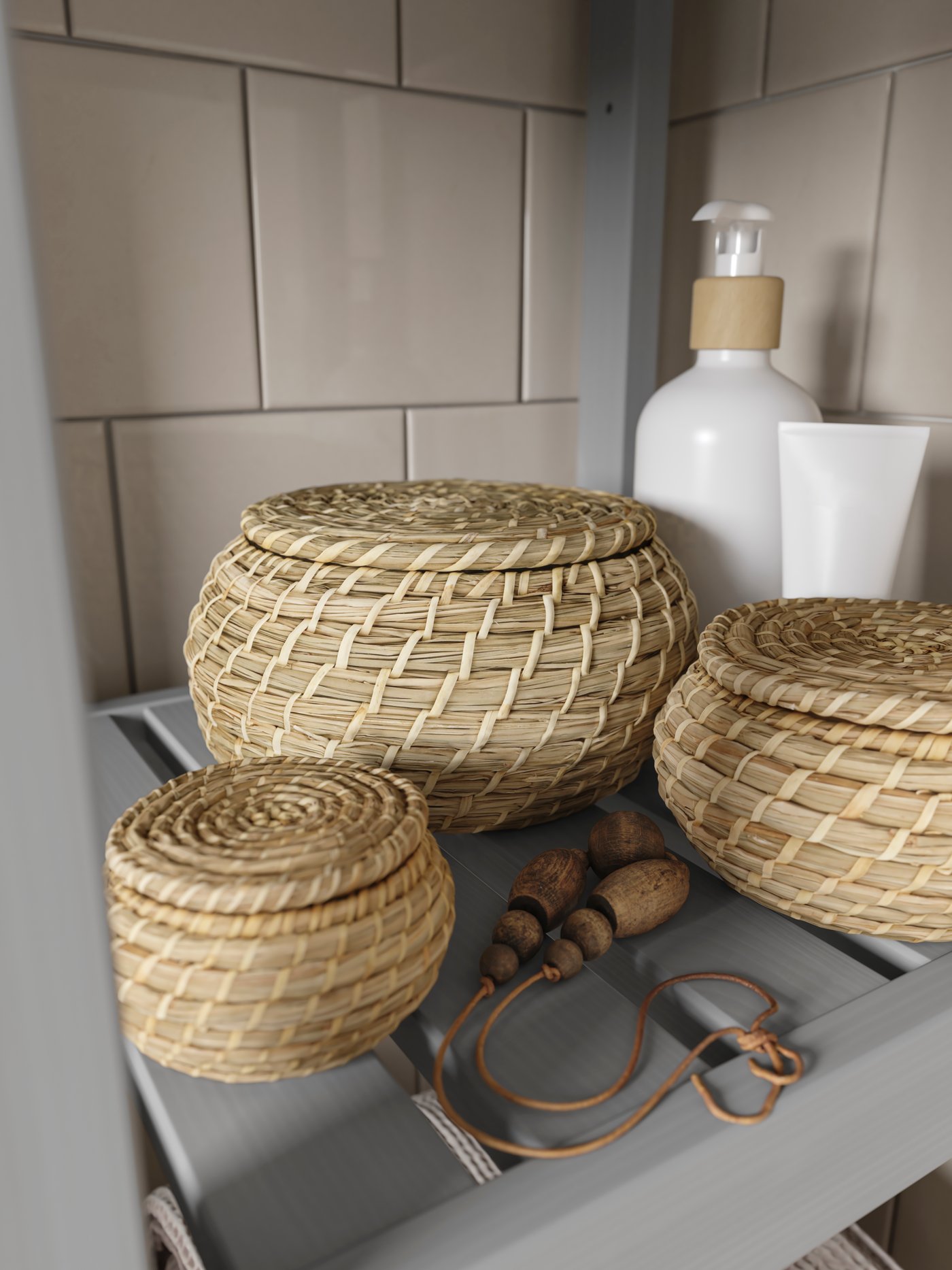 FRYKEN storage baskets are on a bathroom shelf.
