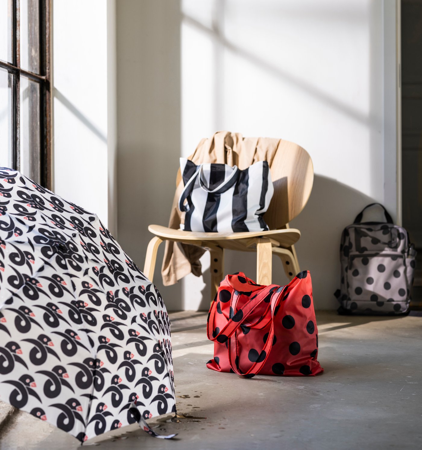 A striped/black white SKYNKE carrier bag