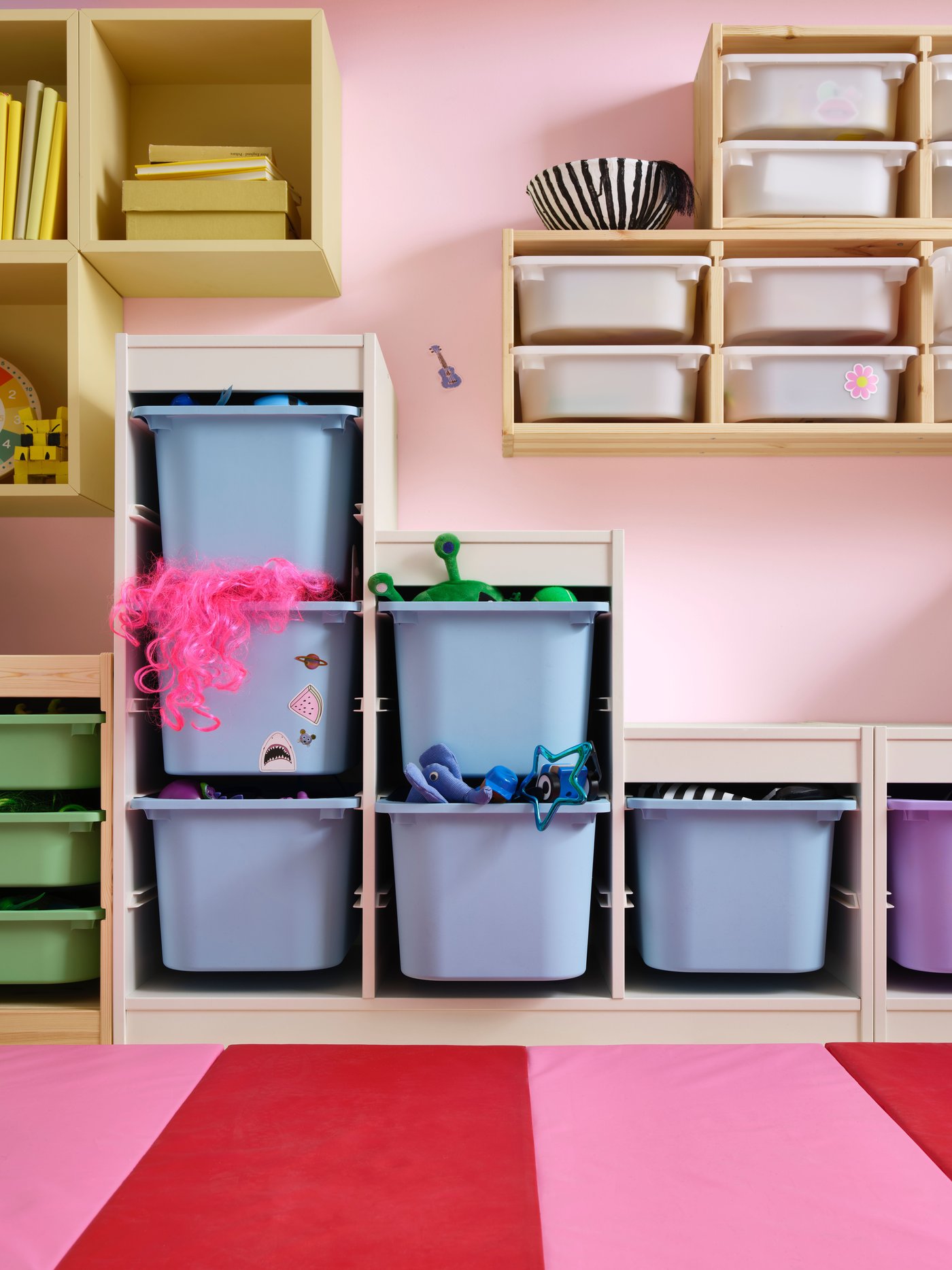 A light white stained pine/white TROFAST wall storage in the childrens room