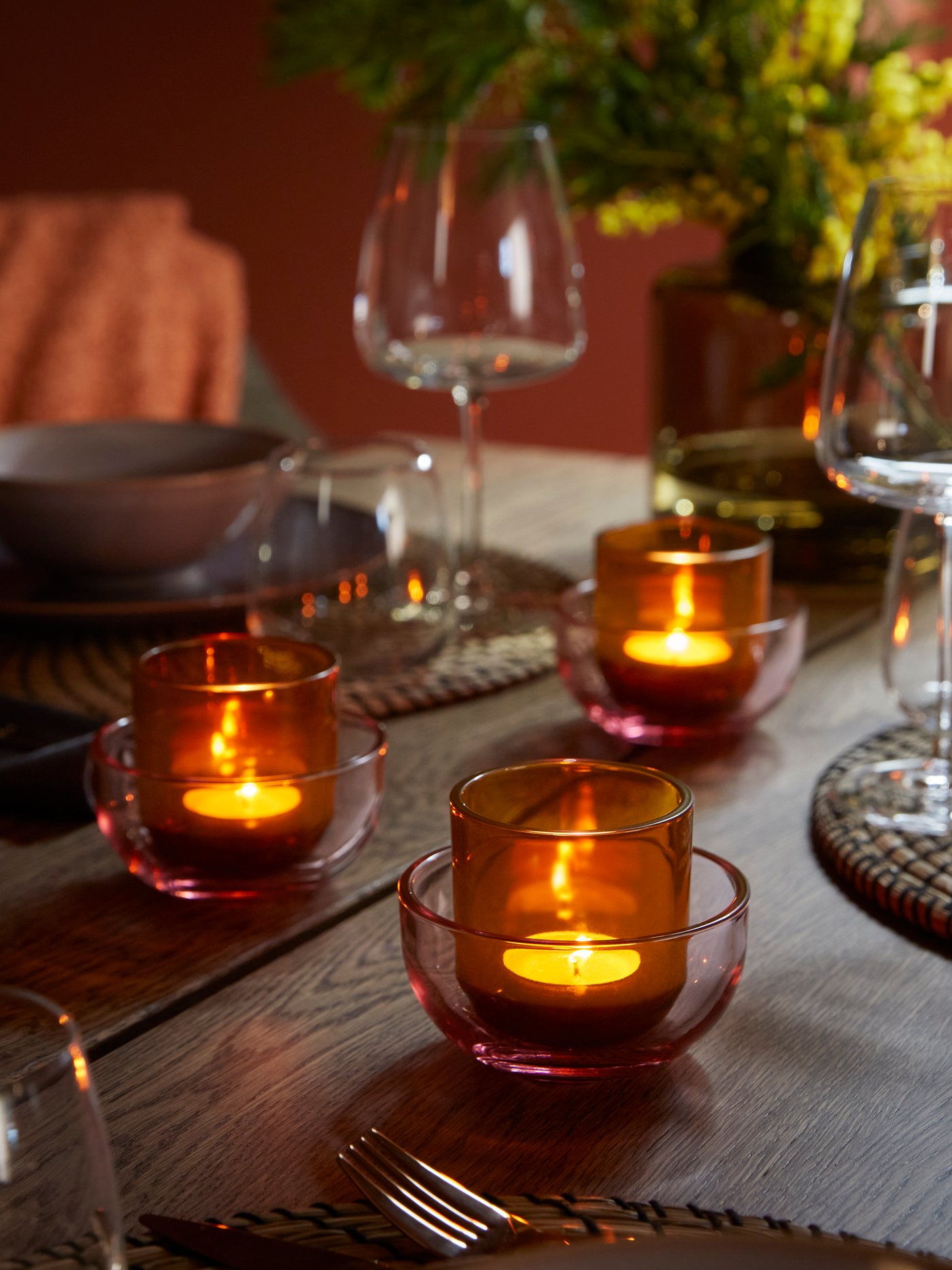 A pink/brown TALLTITA tealight holder in the dining room