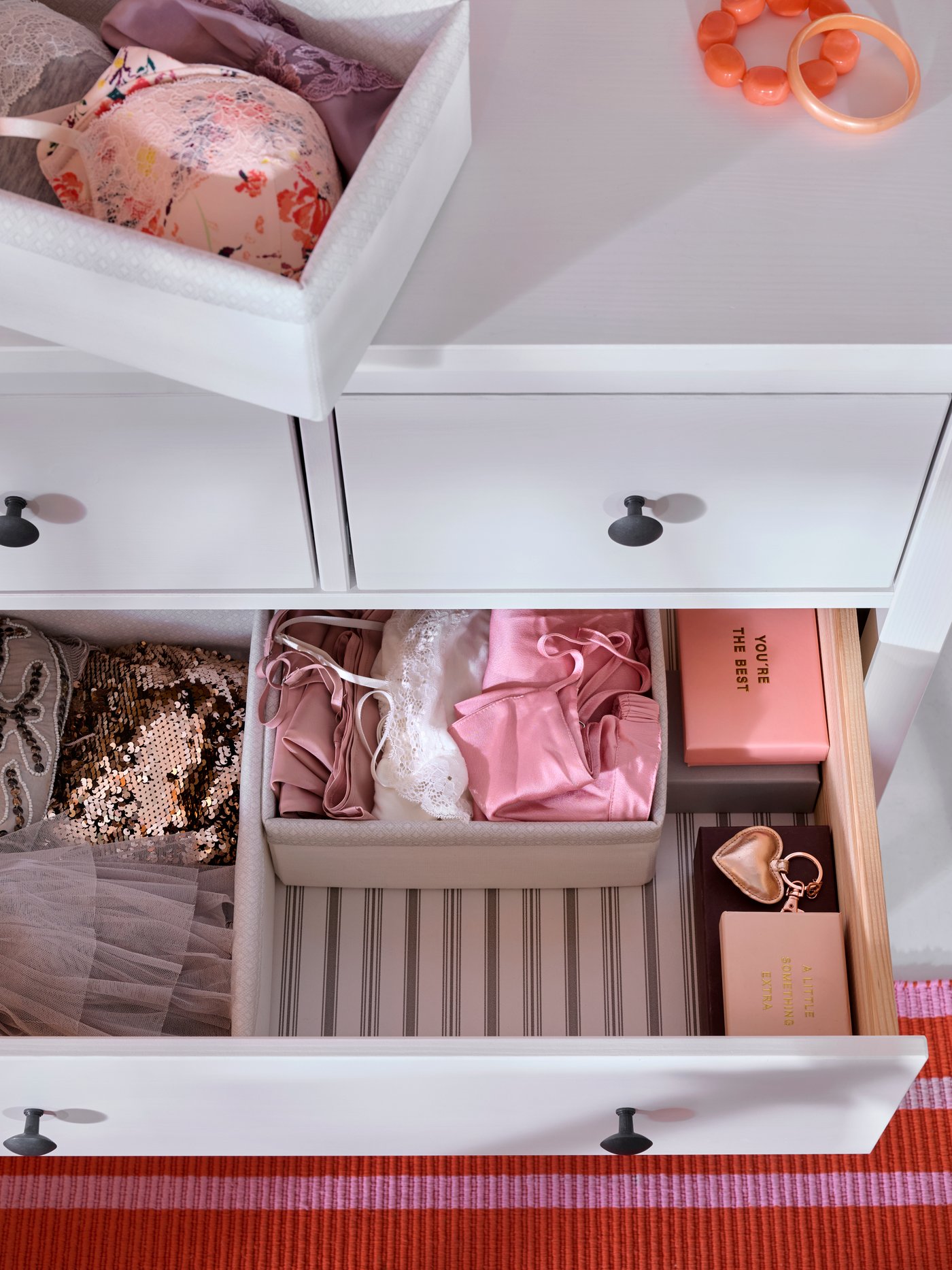 Close-up of HEMNES chest of drawers, taken from above, with one drawer pulled out showing the neat order inside.