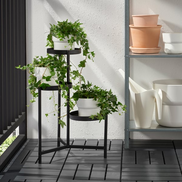 An in/outdoor black OLIVBLAD plant stand outside