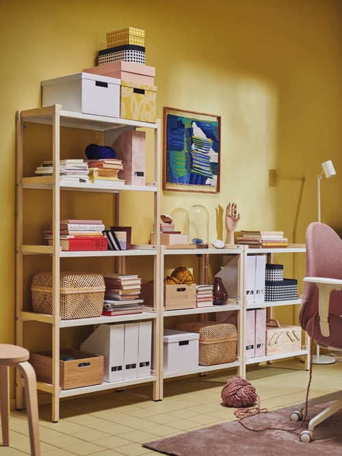 A workspace featuring a brown open shelving unit made of untreated wood storing multiple rectangular boxes with lid.