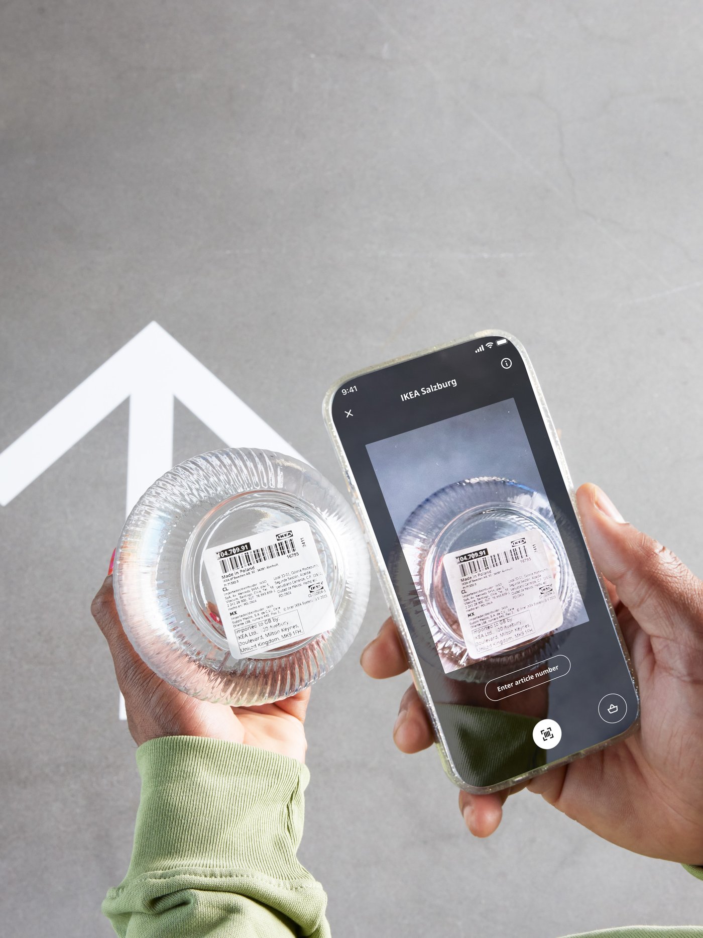 A person using their phone to scan an IKEA product in store.