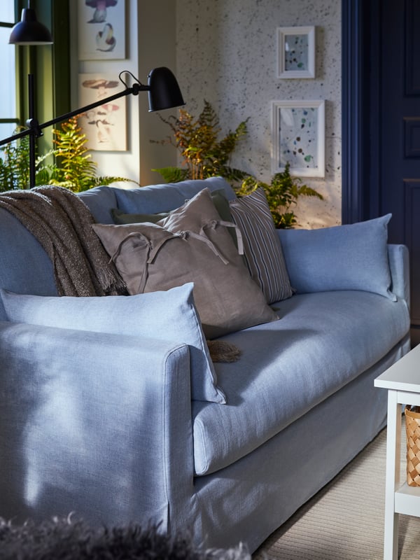 A HYLTARP Kilanda pale blue 2-seat sofa with ANIA beige cushion in a traditional room setting.