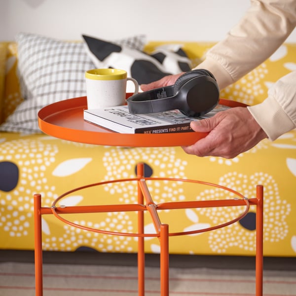 A bright orange GLADOM tray table