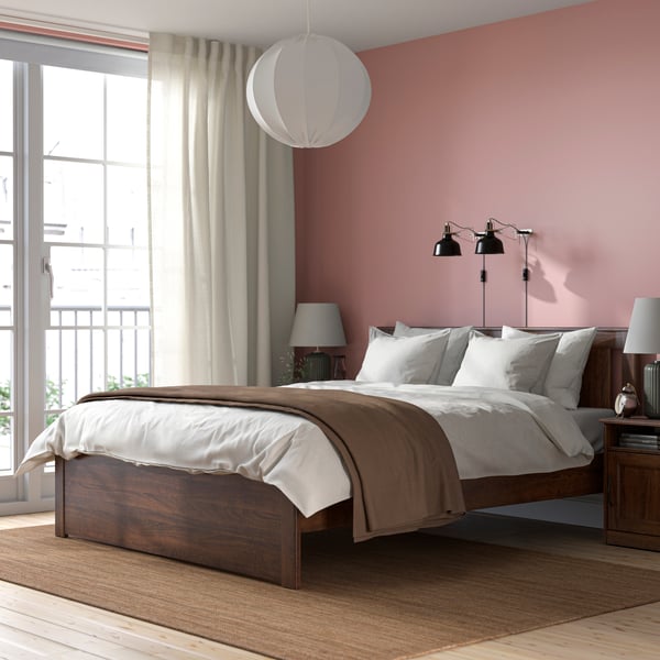 A brown SONGESAND bed frame