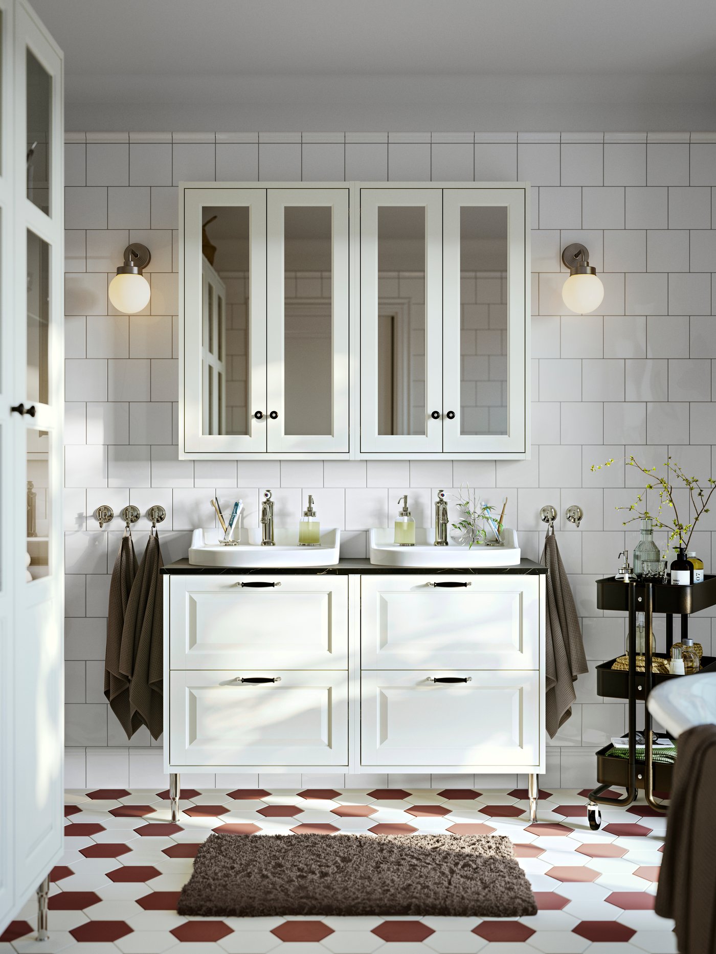 Bathroom with two, TÄNNFORSEN wash stands with drawers, set under two TÄNNFORSEN mirror cabinets. A trolley is to the side.