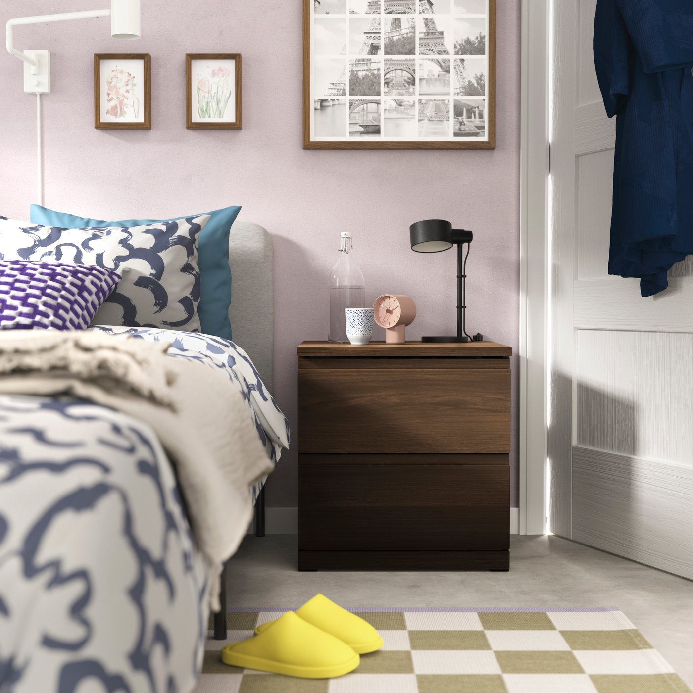 A dark brown oak effect STORKLINTA chest of 2 drawers in the bedroom
