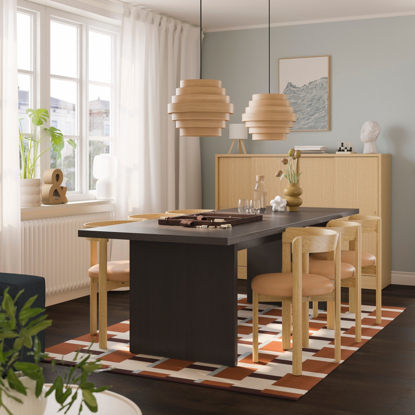 A dark brown ash veneer BERGSHYTTAN table in the dining room