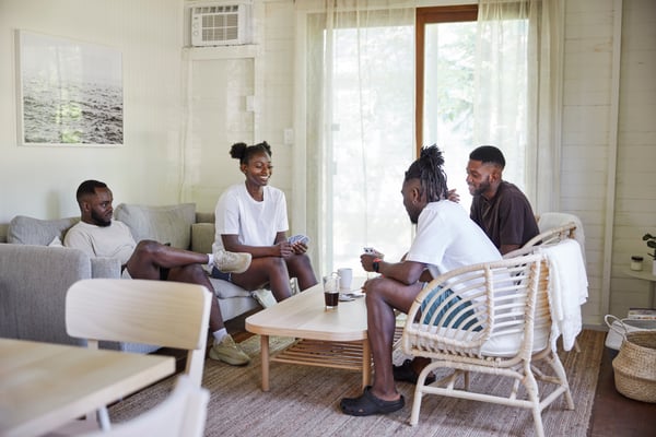 A group of people are playing cards in a living room.