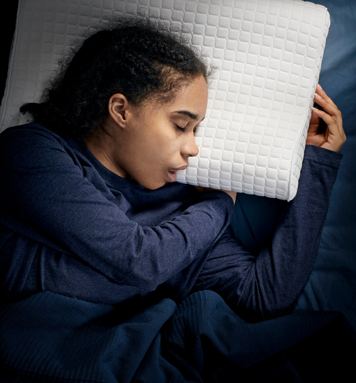a close up shot of a person sleeping on their side