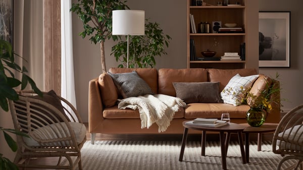 A walnut veneer STOCKHOLM nest of tables in the living room