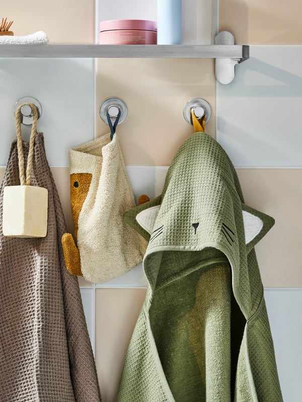 A green GULDVÄVARE baby towel with hood