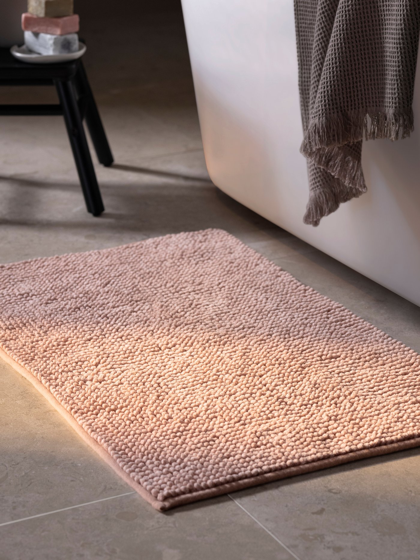 A light pink TOFTBO bath mat
