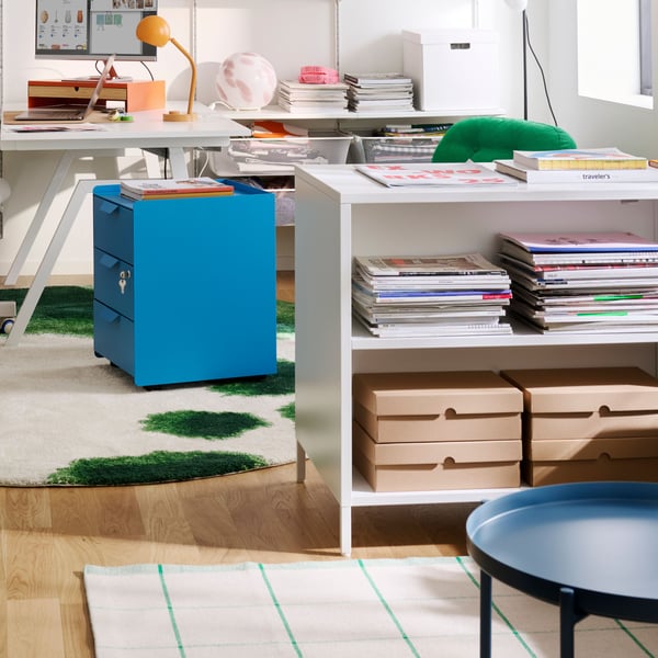 Room divided by a freestanding TROTTEN cabinet.