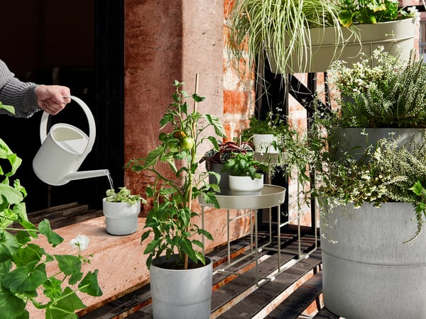 An in/outdoor grey NYPON plant pot outside