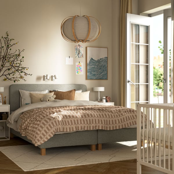 A beige TVERSTED rug, low pile in the bedroom