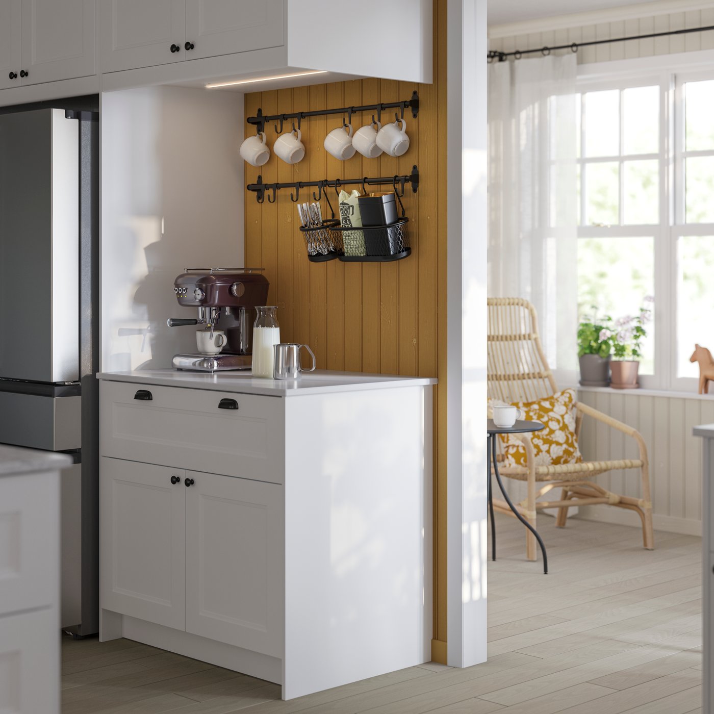 A modern kitchen featuring a white AXSTAD fronts with kitchenware, alongside a stainless steel fridge and dining area.