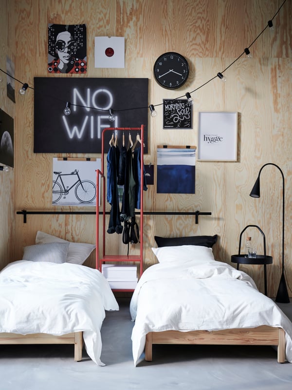 A black DELAKTIG LED floor lamp in the bedroom