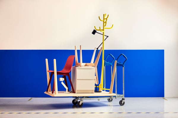Cart with chair, drawer, legs, coat rack and two blue hand trucks.