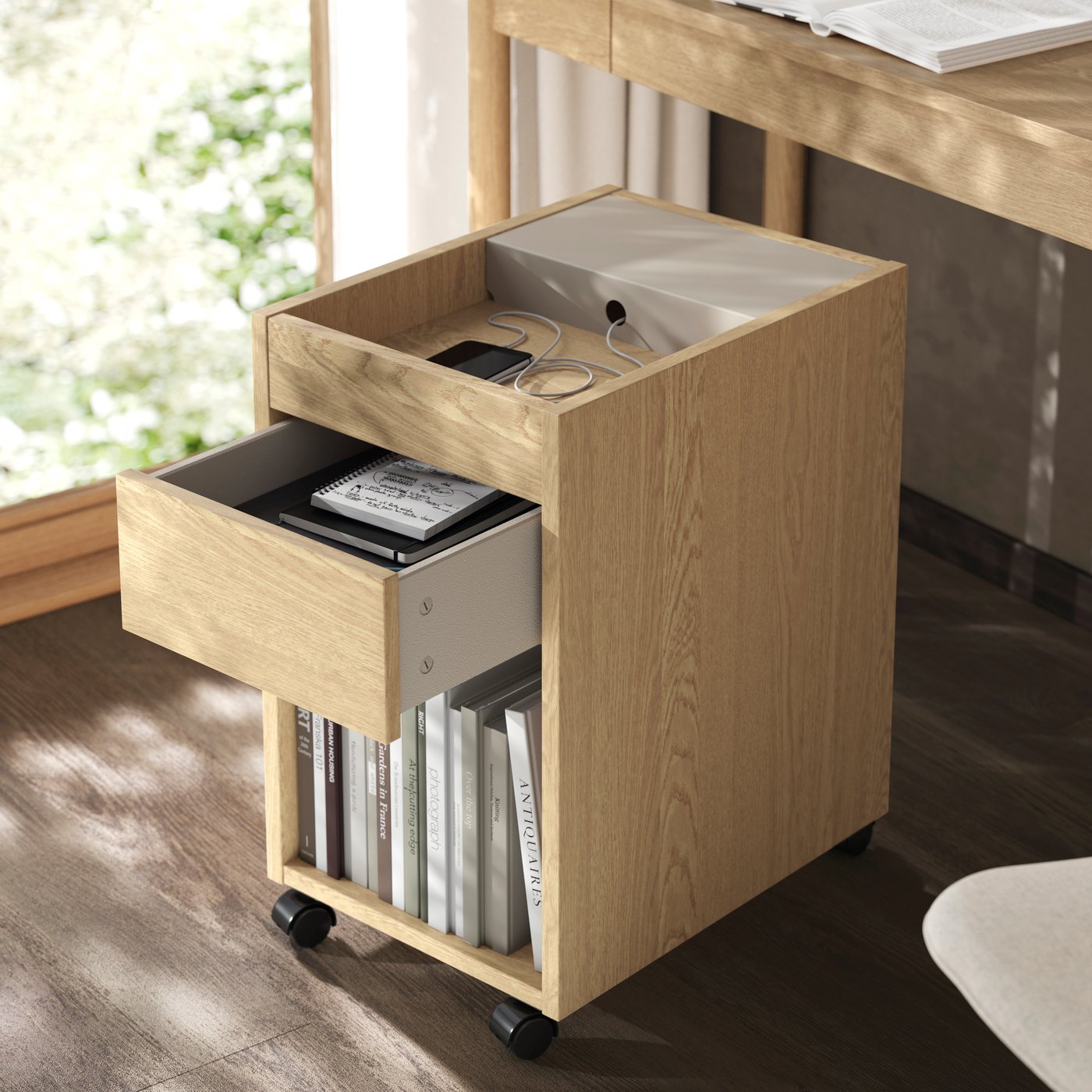 An oak veneer TONSTAD drawer unit on castors