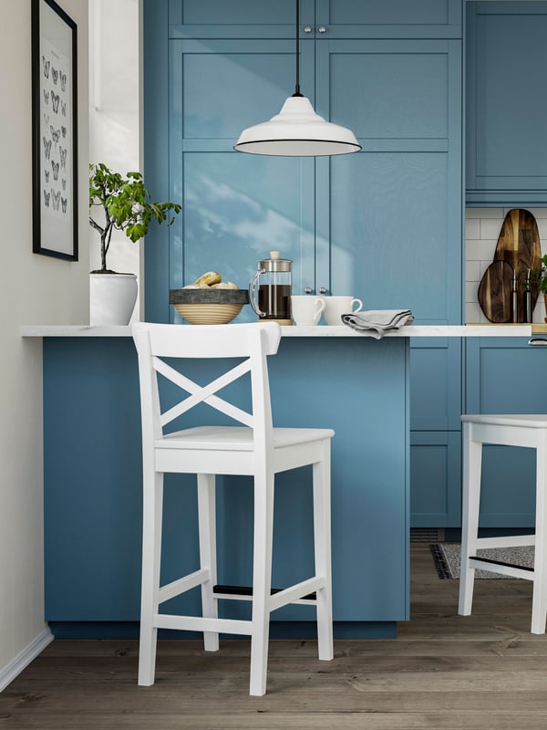 A counter height/white ROSENTORP bar stool with backrest