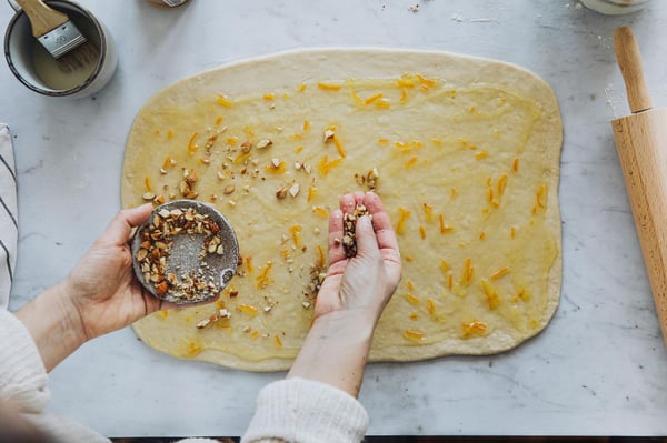 Sprinkle the dough with the roughly chopped nuts