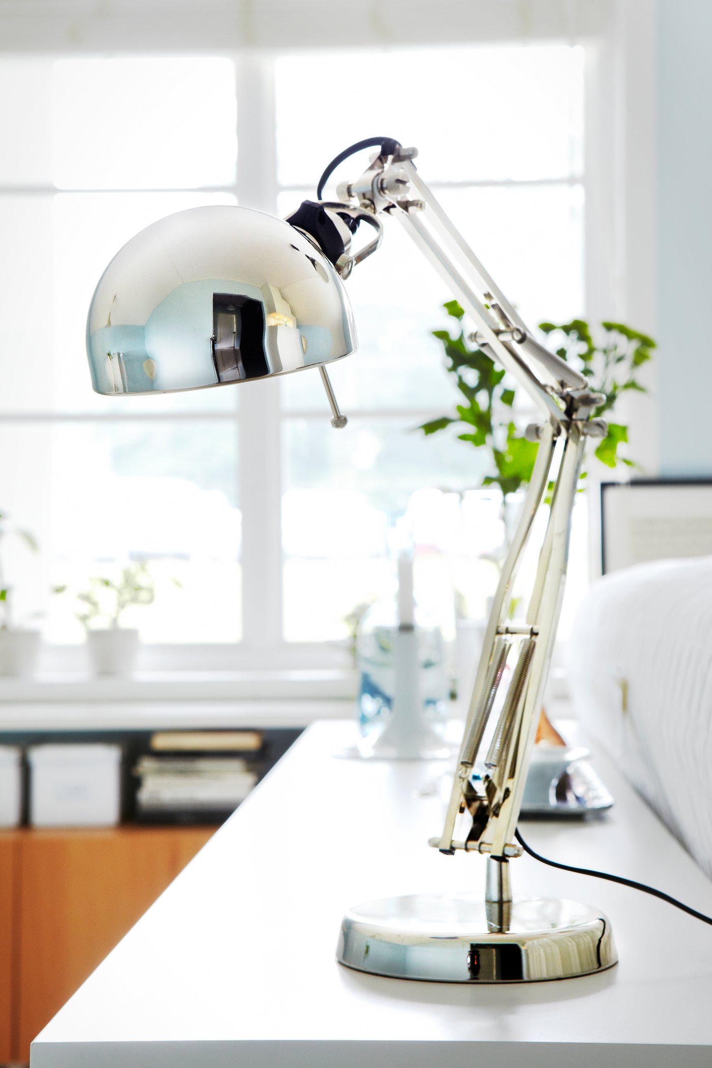 Close-up of a silver-colored FORSÅ desk lamp.