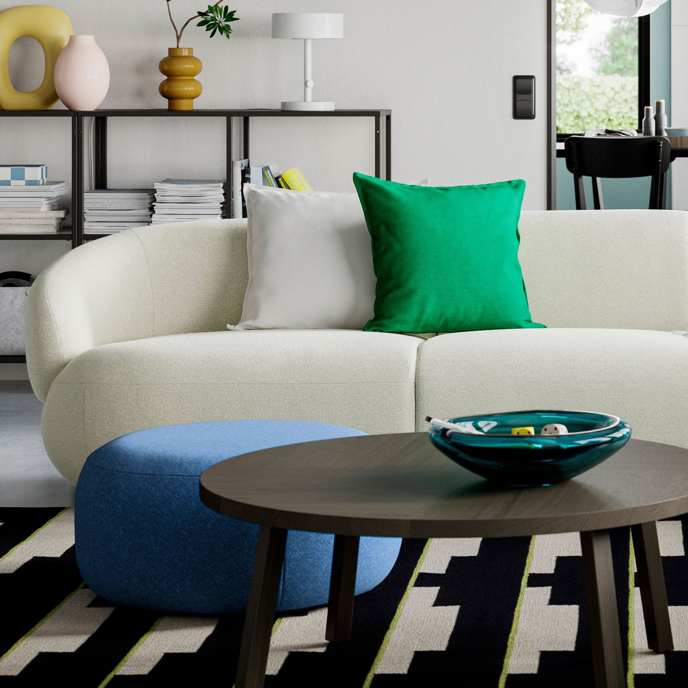 A LILLESÄTER pouffe and a coffee table stand in front of a LILLESÄTER 4-seat sofa with a green extra cushion on it.