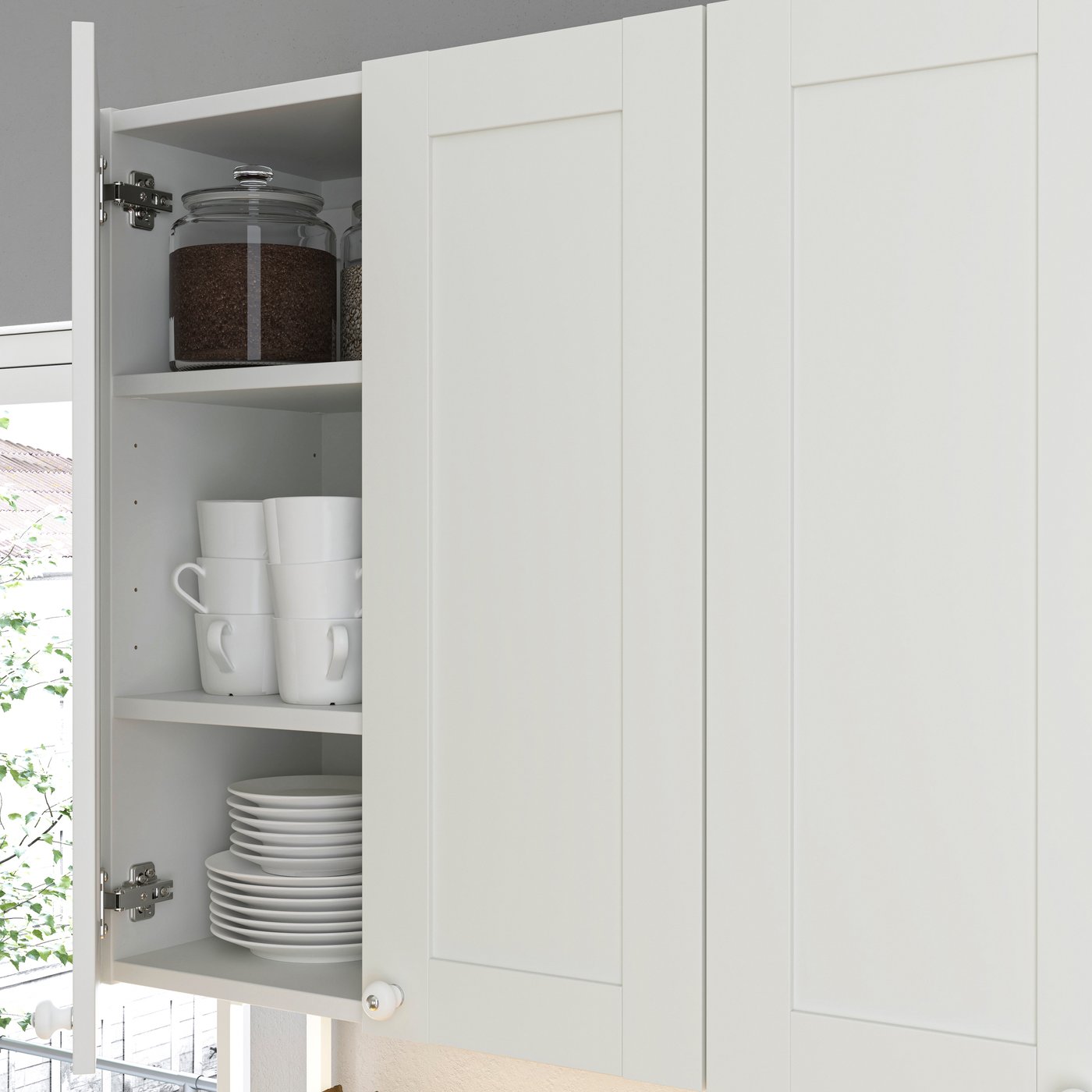 A white frame ENHET wall cabinet with two doors and shelves.